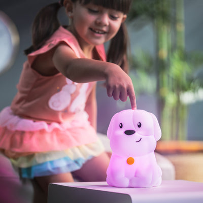 Child touching LumiPuppy with one finger.