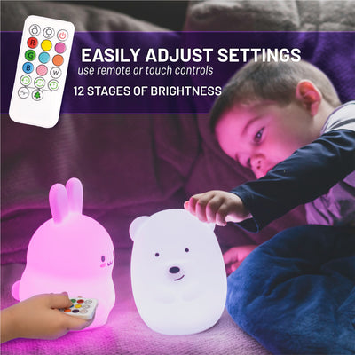 Easily adjust settings - 12 stages of brightness - Boy grabbing LumiBear glowing white with glowing LumiBunny.
