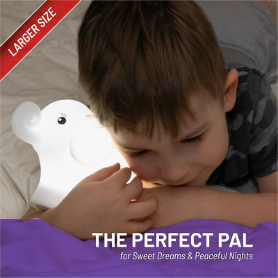 The perfect pal - larger size - boy holding LumiElephant glowing white.