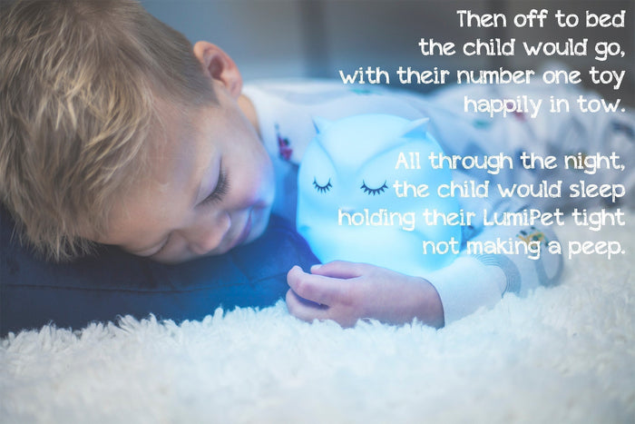 Toddler sleeping peacefully with an Owl LumiPet portable night light for nursery sleep