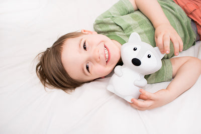 Child holding LumiFox nightlight.