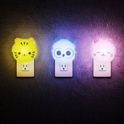 LumiGlow tiger, owl, and cat lit up and plugged into wall outlets.