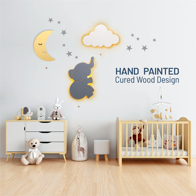 Hand painted cured wood design - LumiDreams moon. elephant, cloud, and star stickers on wall in nursery.