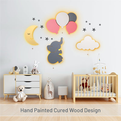 Hand painted cured wood design with LumiDreams moon, elephant. balloons, and cloud with star stickers in nursery.