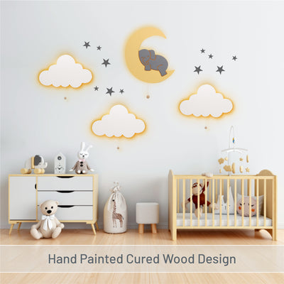 Hand painted cured wood design - LumiDreams cloud, elephant on moon, and star stickers on wall in nursery.