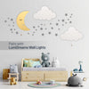Pairs with LumiDreams wall lights - silver star stickers on wall with LumiDreams moon and cloud wall lights in children's bedroom.