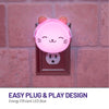 Easy plug and play design with energy efficient LED glow - LumiGlow cat plugged into wall outlet and glowing pink.