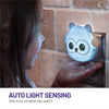 Auto light sensing - only turns on when you need it - LumiOwl plugged in and glowing blue with child's hand underneath it.