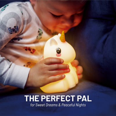 The perfect pal - Boy holding LumiUnicorn nightlight with Bluetooth.