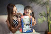 Child and mother with sound soother bear in box.