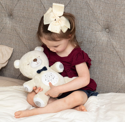 Child with sound soother bear.