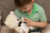 Child with sound soother bear.