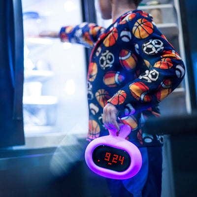 Boy holding bunny LumiClock to get a snack out of the fridge